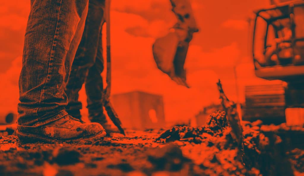Employees Standing in Front of Excavator
